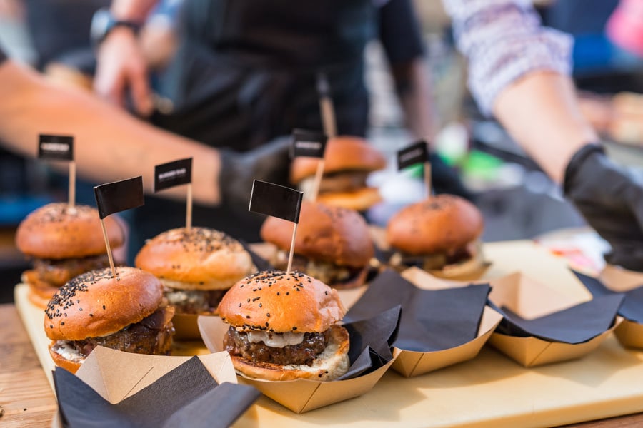Chef Making Beef Burgers Outdoor on Open Kitchen International Food Festival Event